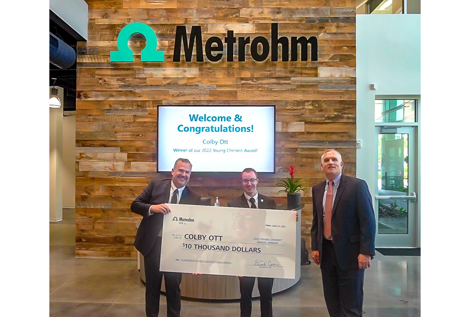 Dr. Colby Ott (center) receiving the Metrohm USA Young Chemist Award in 2022.
